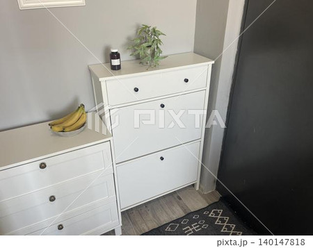 The jar of medicine is on the left side of the large cabinet 140147818