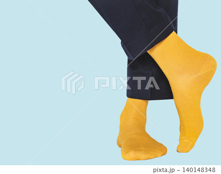 Man wearing bright yellow socks with black pants Man wearing bright yellow socks with black pants 140148348