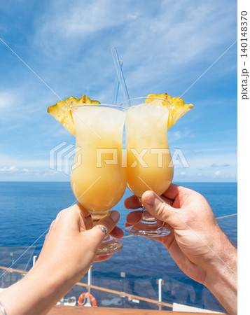 Two hands holding a glasses of drink Two hands holding a glasses of drink 140148370