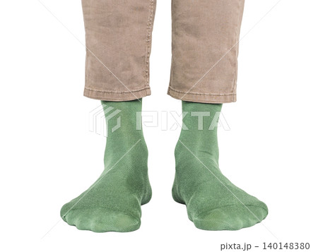 Man wearing bright green socks with black pants 140148380