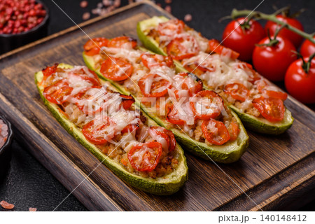 Baked zucchini half with minced meat, tomatoes, cheese, salt, and spices. Zucchini with minced meat Baked zucchini half with minced meat, tomatoes, cheese, salt, and spices. Zucchini with minced meat 140148412