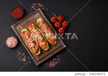 Baked zucchini half with minced meat, tomatoes, cheese, salt, and spices. Zucchini with minced meat 140148415