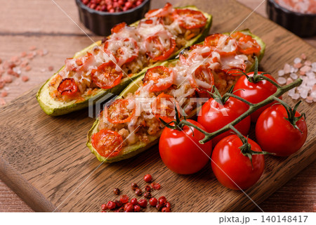 Baked zucchini half with minced meat, tomatoes, cheese, salt, and spices. Zucchini with minced meat Baked zucchini half with minced meat, tomatoes, cheese, salt, and spices. Zucchini with minced meat 140148417