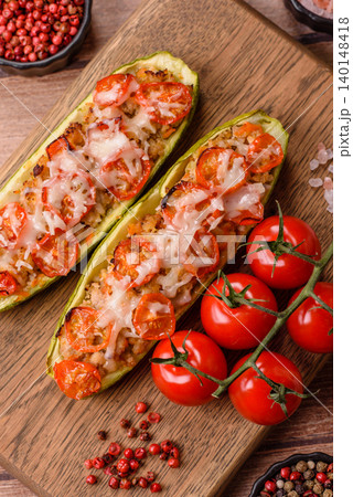 Baked zucchini half with minced meat, tomatoes, cheese, salt, and spices. Zucchini with minced meat Baked zucchini half with minced meat, tomatoes, cheese, salt, and spices. Zucchini with minced meat 140148418