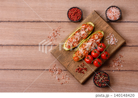 Baked zucchini half with minced meat, tomatoes, cheese, salt, and spices. Zucchini with minced meat Baked zucchini half with minced meat, tomatoes, cheese, salt, and spices. Zucchini with minced meat 140148420