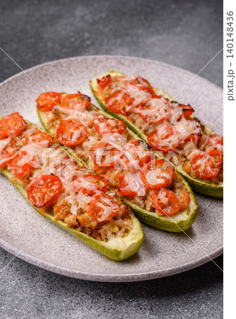 Baked zucchini half with minced meat, tomatoes, cheese, salt, and spices. Zucchini with minced meat Baked zucchini half with minced meat, tomatoes, cheese, salt, and spices. Zucchini with minced meat 140148436