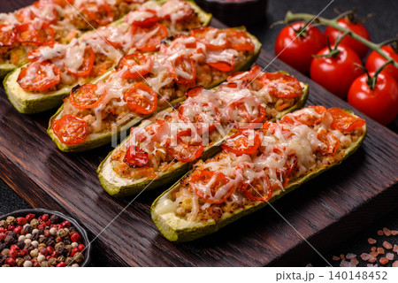 Baked zucchini half with minced meat, tomatoes, cheese, salt, and spices. Zucchini with minced meat Baked zucchini half with minced meat, tomatoes, cheese, salt, and spices. Zucchini with minced meat 140148452