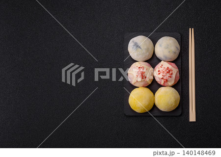Japanese sweet frozen mochi with rice dough, fruit, and chocolate filling. Japanese mochi Japanese sweet frozen mochi with rice dough, fruit, and chocolate filling. Japanese mochi 140148469