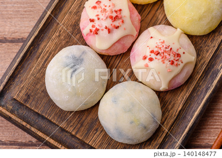 Japanese sweet frozen mochi with rice dough, fruit, and chocolate filling. Japanese mochi Japanese sweet frozen mochi with rice dough, fruit, and chocolate filling. Japanese mochi 140148477