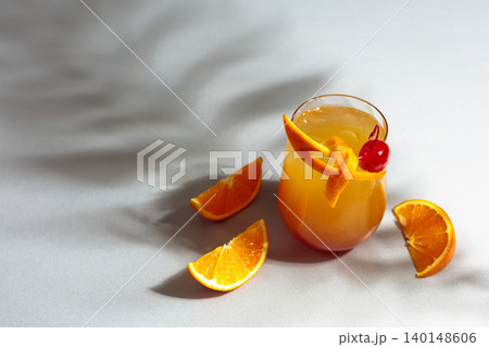 Cocktail Tequila sunrise with orange juice, silver tequila, grenadine, and ice. Cocktail Tequila sunrise with orange juice, silver tequila, grenadine, and ice. 140148606