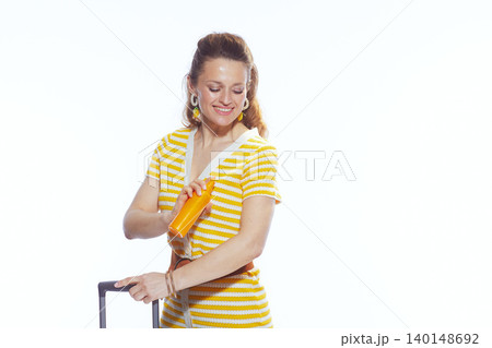 Applying Sunscreen for Summer Holiday - Woman with Suitcase 140148692