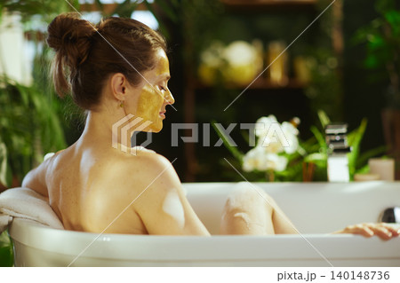 Tranquil Back View: Woman in Spa Bathtub Tranquil Back View: Woman in Spa Bathtub 140148736