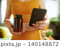 Healthy Woman Using App to Track Supplements 140148872