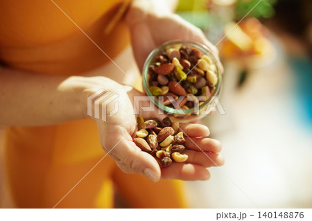 Woman Holding a Jar of Gourmet Mixed Nuts 140148876