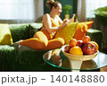 Fresh Fruit Basket with Woman Relaxing in Background 140148880