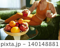 Fit Woman Reaching for a Healthy Snack of Fresh Fruit 140148881