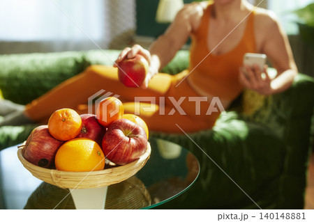 Fit Woman Reaching for a Healthy Snack of Fresh Fruit Fit Woman Reaching for a Healthy Snack of Fresh Fruit 140148881