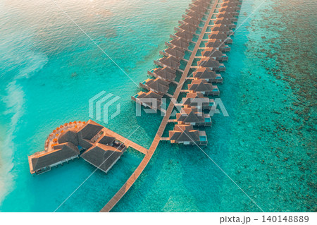 Gorgeous aerial Maldives overwater villas turquoise reef lagoon breathtaking luxury resort top view tropical paradise serene idyllic coastal escape drone dreamy vibrant exotic getaway scenic Gorgeous aerial Maldives overwater villas turquoise reef lagoon breathtaking luxury resort top view tropical paradise serene idyllic coastal escape drone dreamy vibrant exotic getaway scenic 140148889