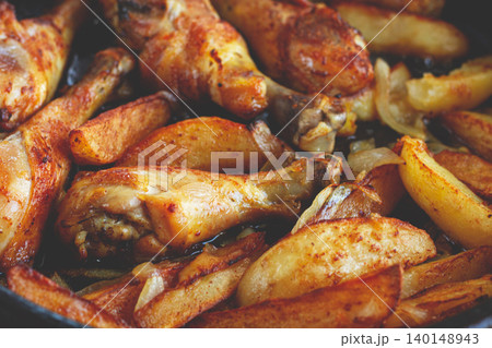 fried chicken drumsticks with potato slices, in a clay pan, baked in the oven, with spices, homemade, no people, fried chicken drumsticks with potato slices, in a clay pan, baked in the oven, with spices, homemade, no people, 140148943