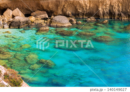Aerial view Mediterranean cove vibrant blue green water texture rocky shores summer vacation nature landscape destination 140149027