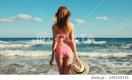 Summer vacation, relaxed beautiful young woman in swimsuit, tourist hat on the beach on sea coast Summer vacation, relaxed beautiful young woman in swimsuit, tourist hat on the beach on sea coast 140149338