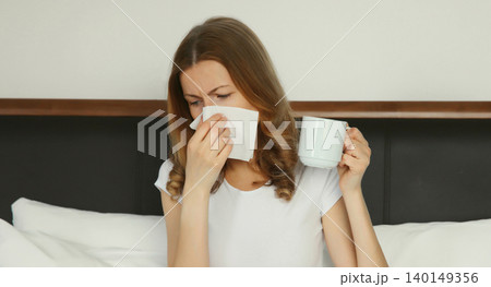 Sick exhausted young woman sneezing blow nose using tissue, unhealthy suffering girl feels unwell Sick exhausted young woman sneezing blow nose using tissue, unhealthy suffering girl feels unwell 140149356