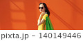 Portrait of stylish beautiful young woman posing with shopping bags 140149446