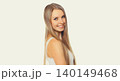 Portrait of beautiful blonde smiling young woman with long hair on white background 140149468