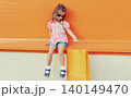 Little girl child with shopping bags posing on city street 140149470