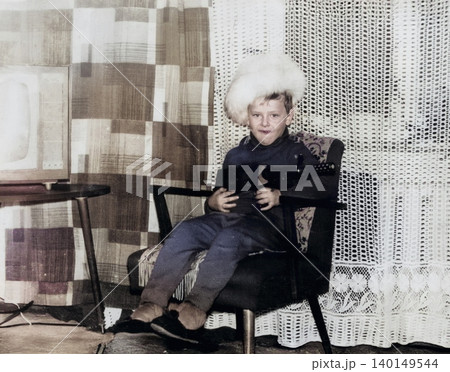 Soviet boy in winter clothing at home during childhood in the early 1970s 140149544