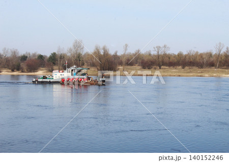 A small boat sails along the river in summer A small boat sails along the river in summer 140152246