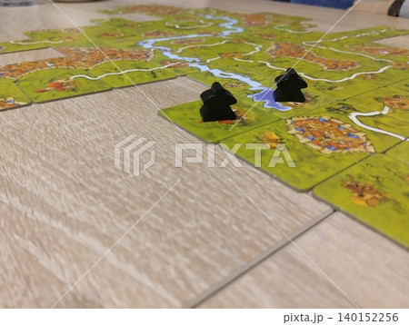 Mozyr, Belarus, April 10 2025: board game Carcassonne. Black Player Chips Mozyr, Belarus, April 10 2025: board game Carcassonne. Black Player Chips 140152256