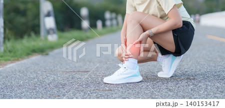 Young adult woman runner suffering from acute calf muscle pull and leg ache during running workout. female athlete holding his painful leg due to sports injuries. Medical and healthcare concept Young adult woman runner suffering from acute calf muscle pull and leg ache during running workout. female athlete holding his painful leg due to sports injuries. Medical and healthcare concept 140153417
