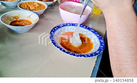 A close-up of papeda, a traditional Papuan and Maluku dish. It has a thick texture and a bland taste, but is delicious when paired with yellow fish soup or other side dishes. A close-up of papeda, a traditional Papuan and Maluku dish. It has a thick texture and a bland taste, but is delicious when paired with yellow fish soup or other side dishes. 140154858