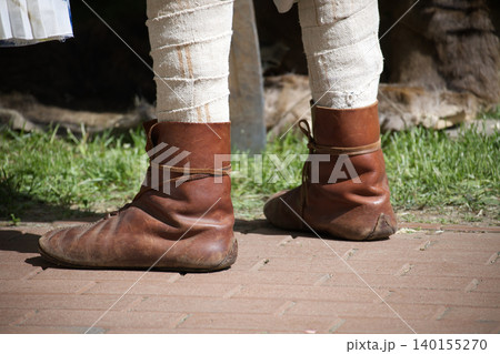 Medieval Leather Boots And Leg Wraps Worn By Historical Reenactor At Outdoor Event 140155270