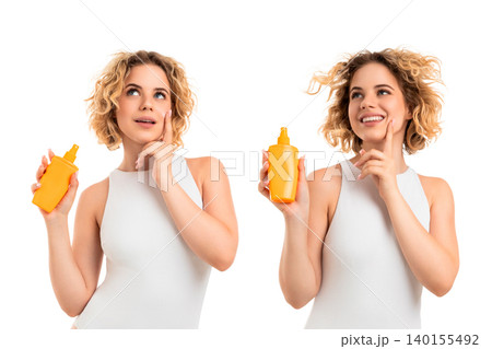 Woman holds sunscreen while contemplating summer skincare, PNG 140155492