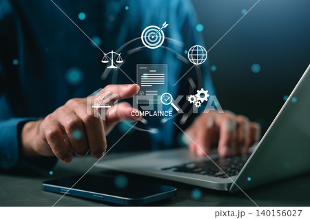 Corporate professional ensures compliance, laws, laws, regulations, standards, business, policies, compliance using laptop, smartphone, touching legal icons for digital system governance 140156027