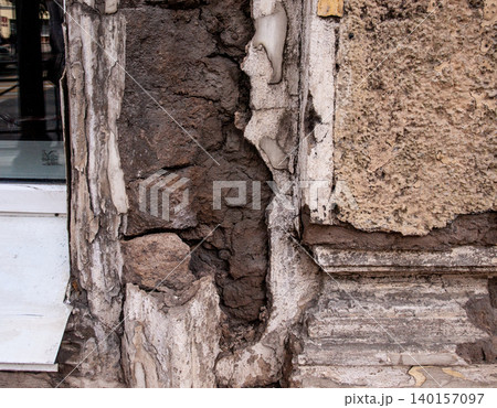 Fragment of a historical building facade in urgent need of restoration. Fragment of a historical building facade in urgent need of restoration. 140157097