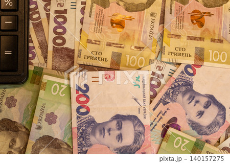 Background of various Ukrainian hryvnia banknotes with calculator close up Background of various Ukrainian hryvnia banknotes with calculator close up 140157275