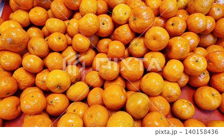 Abundance of Fresh Ripe Tangerines Displayed at a Local Market for Sale 140158436