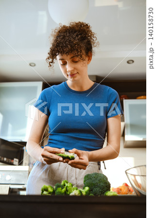 Preparation of smashed broccoli with cheese in a home kitchen during the day Preparation of smashed broccoli with cheese in a home kitchen during the day 140158730