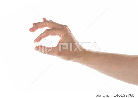 Male hand hold transparent pill isolated on white Male hand hold transparent pill isolated on white 140158769