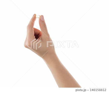 Female hand hold transparent pill isolated on white Female hand hold transparent pill isolated on white 140158812
