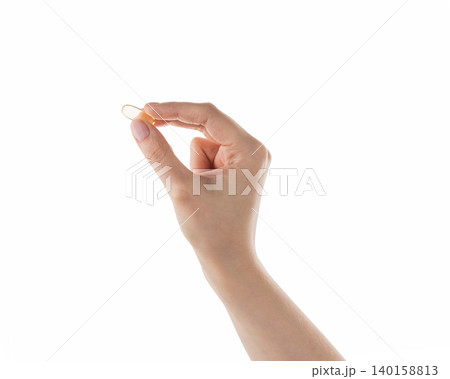 Female hand hold transparent pill isolated on white Female hand hold transparent pill isolated on white 140158813