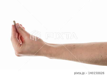 Male hand show brown pill isolated on white 140158826