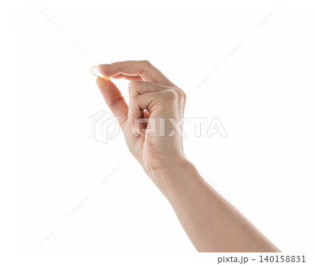 Female hand hold transparent pill isolated on white 140158831