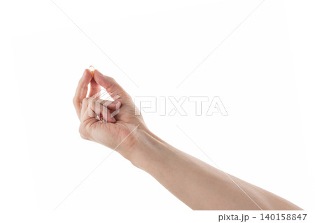 Male hand hold transparent pill isolated on white Male hand hold transparent pill isolated on white 140158847