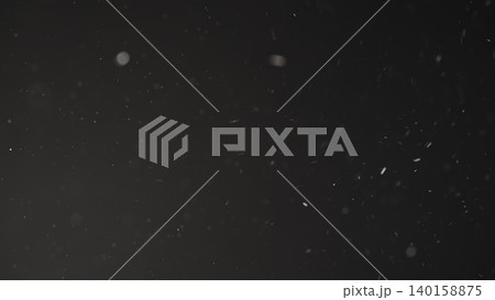 Slow motion real dust particles floating mid air over dark background 140158875