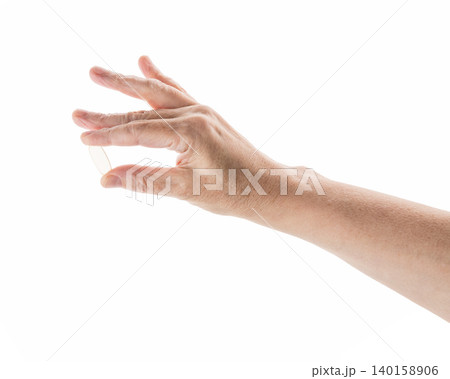 Mid aged female hold transparent pill isolated on white Mid aged female hold transparent pill isolated on white 140158906