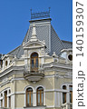 Ornate European historic building facade with balcony and roof 140159307